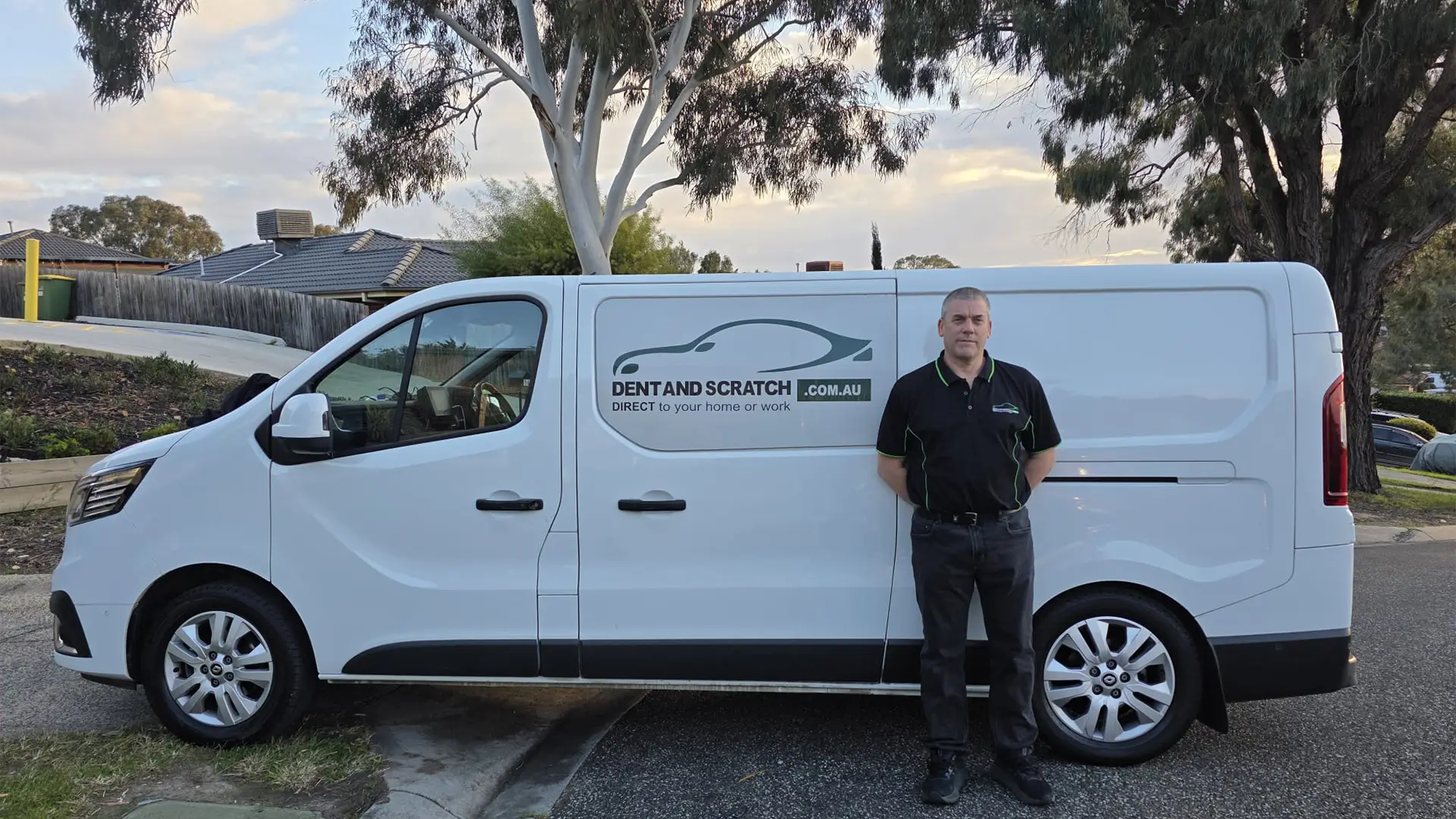 Diarmuid standing beside the branded Dent and Scratch Direct work van, parked on a suburban street