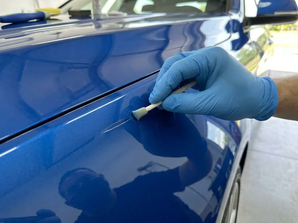 Paint repair colour-matched on a panel